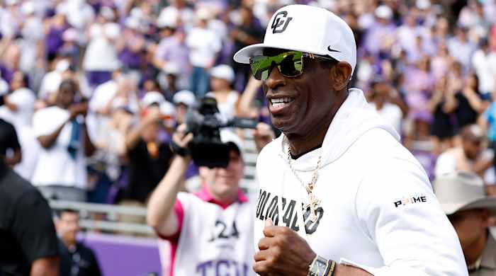 Deion Sanders runs onto the field for Colorado vs. TCU.